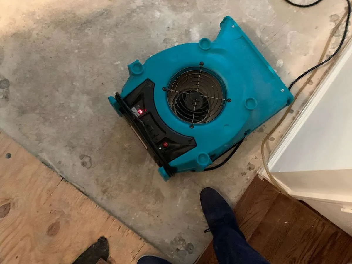Air mover drying subfloor during Commercial Water Damage Restoration in Hudsonville